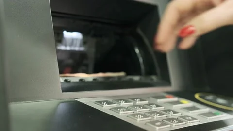 A young woman iusing an ATM machine to get money from her credit card. Stock Footage 202569822