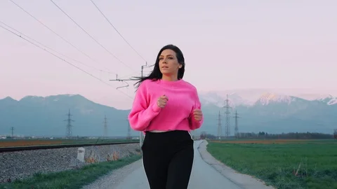 Young woman Jogging by the Fields Stock Footage 129521974