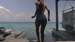sexy woman taking off clothes jumping in, Stock Video