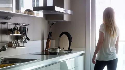 Young woman in the kitchen Stock Footage 75768522
