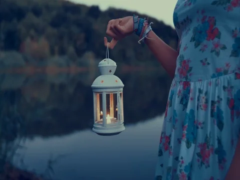 Young woman with lantern exploring in nature Stock Footage 79595387