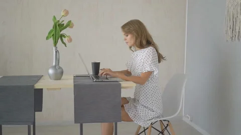 Young woman with laptop computer having chat at home Stock Footage 88485555