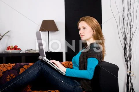 Young Woman With A Laptop In The Living Room