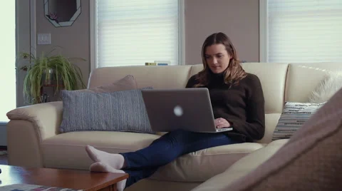 Young woman on laptop, slide in Stock Footage