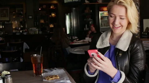 A Young Woman Laughs while Receiving a Text Message Stock Footage 46017748