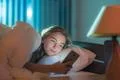 The young woman lay on the bed and phone Photo
