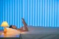 The young woman lay on the bed and phone. Evening night time Photo