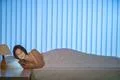 The young woman lay on the bed and phone. Evening night time Photo