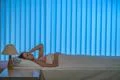 The young woman lay on the bed. Evening night time Photo