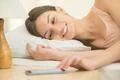 The young woman lay on the bed with smartphone Photo