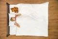 The young woman lay on the bed with the soft toy. View from above Photo