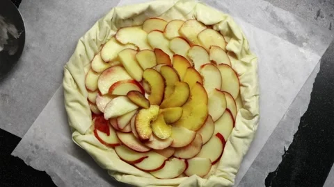 Young woman learning to bake a fruit tart using online video tutorial Stock Footage 336848409
