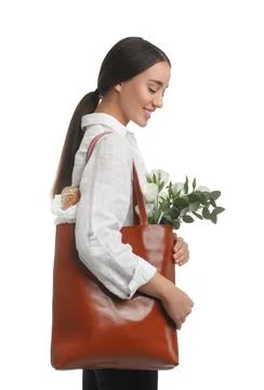 Young woman with leather shopper bag on white background Stock Photos