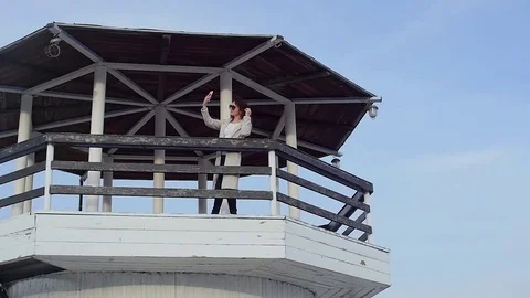 The young woman at the lighthouse. developing hair.slow motion Stock-Footage 75390033
