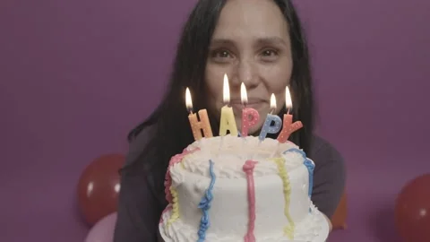 Young Woman Lighting &amp; Blowing Out Cake Candles Infront Of Her Face Stock Footage 227750341