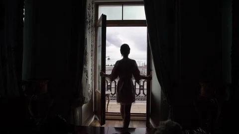 Young woman in lingerie opens balcony doors Stock Footage