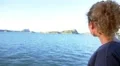 Young Woman Listening to Music on Headphones on the Sailing Ship. Slow Motioin. HD Footage