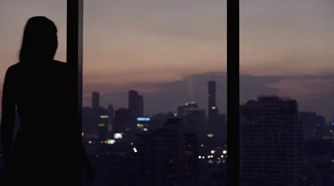 Young woman looking at cityscape at night Stock Footage 59124875