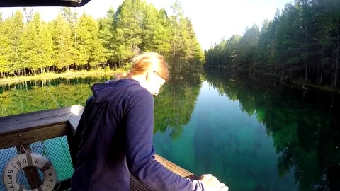 Young woman looking down into cold springs Stock Footage 81761068