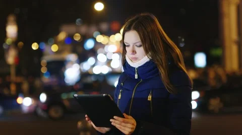 Young woman looking at a map on the tablet Stock Footage 58453971