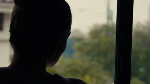 Young Woman Looking Out The Window During Pandemic Quarantine Lockdown Stock Footage