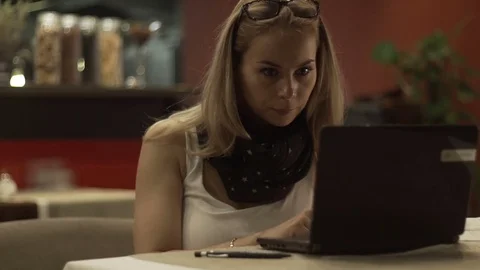 Young woman looking on screen notebook and reading news in social networks Stock Footage 83728067