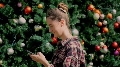 Young woman looking at smartphone while browsing gifts online... Stock Footage 323733041