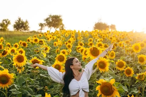 The young woman is looking at something while posing. Stock Photos
