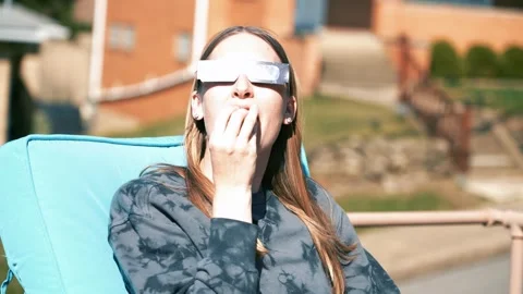 Young Woman Looks at Solar Eclipse  	 Stock Footage 268342847