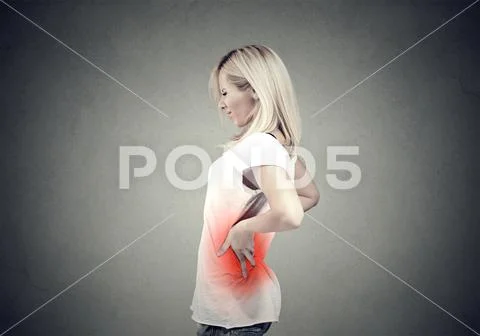 Young woman with lower back pain colored in red Stock Photos