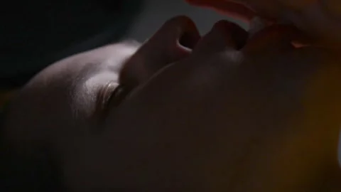 Young woman lying and stuffing her mouth with large amounts of popcorn Stock Footage 336900515