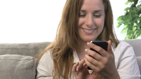  Young Woman Lying On Sofa Using Mobile Phone  1 Stock Footage 210229776