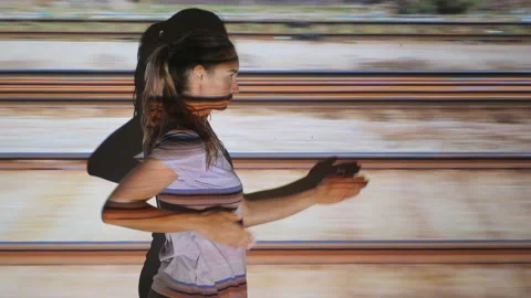 Young woman makes train motion with arms. Tracks moving past. Stock Footage 186892412