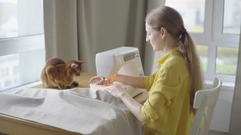 Young woman making clothes using sewing machine Stock Footage 229640608