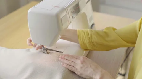 Young woman making clothes using sewing machine Stock Footage 229640609