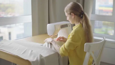 Young woman making clothes using sewing machine Stock Footage 229640610