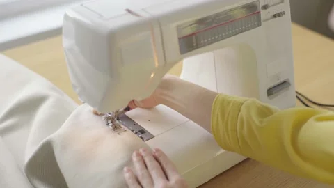 Young woman making clothes using sewing machine Stock Footage 229640615