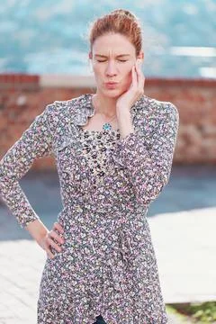 Young woman making face while reacting on calling Stock Photos