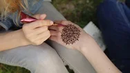 Young Woman Making Floral Mehendi On A Hand Using Henna. Stock Footage