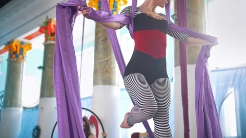 Young woman making gymnastic elements on aerial silk Stock Footage 87987170