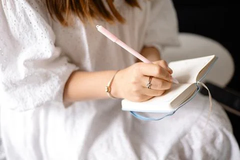 Young woman making notes in a notepad Stock Photos