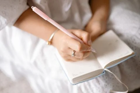 Young woman making notes in a notepad Stock Photos