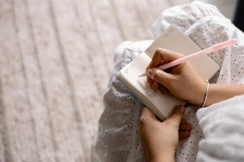 Young woman making notes in a notepad Stock Photos