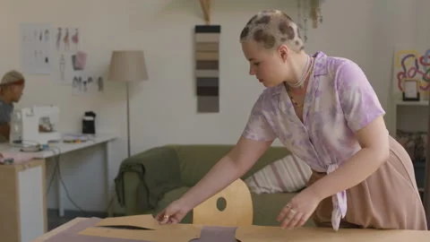 Young Woman Making Pattern on Cloth while Working in Designer Workshop Stock Footage 310856847