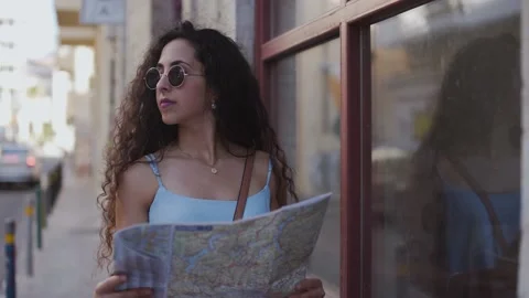 Young woman with map doing sightseeing in old European town Stock Footage 131307241