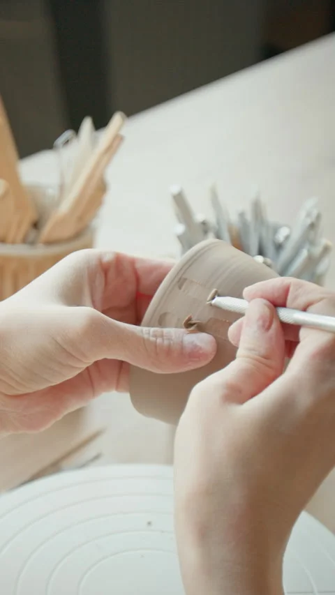 Young Woman Marking Clay Object with Tool in Workshop Stock Footage 331811224
