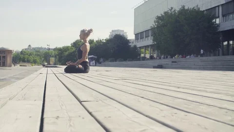 Young woman meditating outdoors Stock Footage