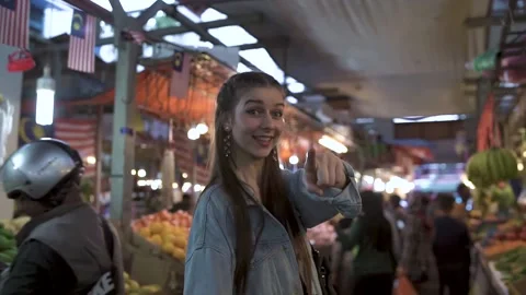 A young woman middle eastern walking at the fruit market Stock Footage 131915210