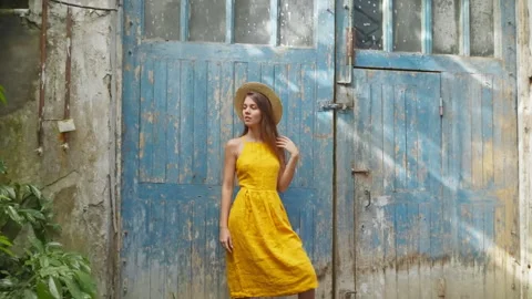 Young woman model standing posing near blue old wooden doors. Stock Footage 260423792