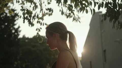 A young woman moves gracefully while doing qigong exercises alone Stock Footage 257670178
